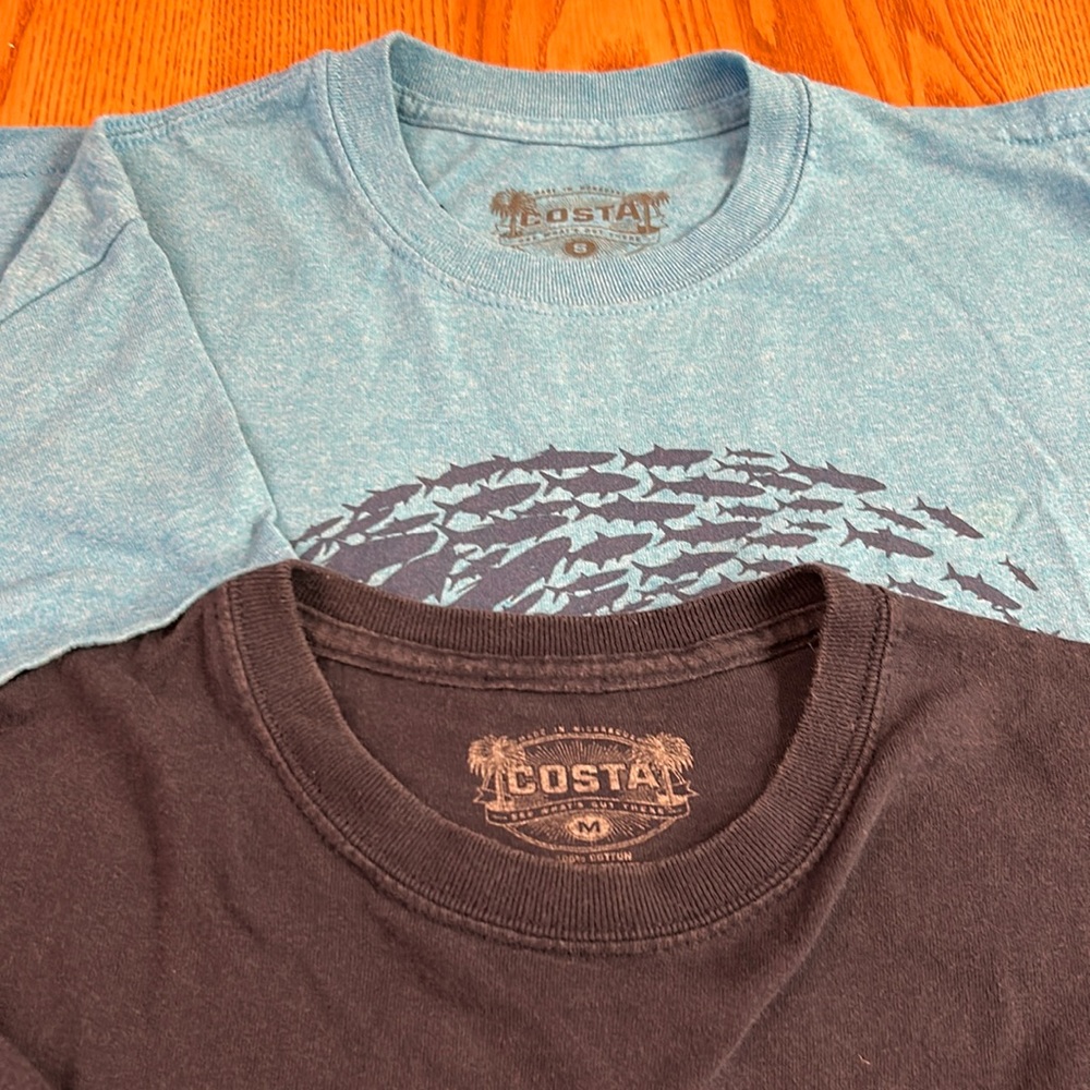 Two blue Costa medium and small tshirts
